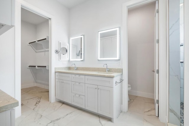 13312 Galleria Cir, Austin, TX 78738 - bathroom with marble look tiles, double vanity, baseboards, and toilet