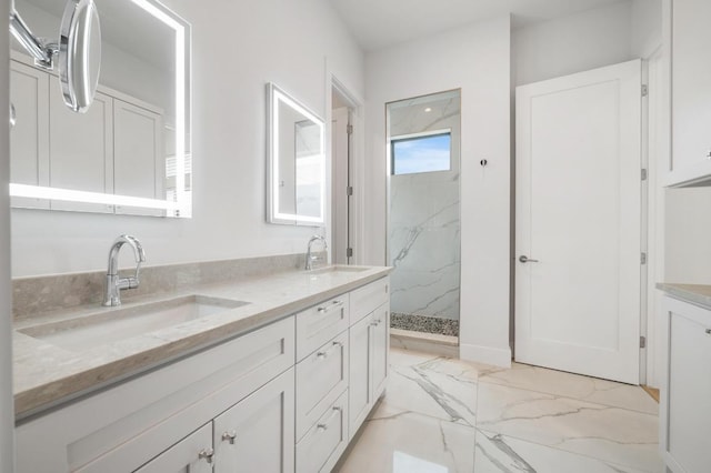 full bathroom featuring double vanity, a marble finish shower, a sink, and marble finish floor
