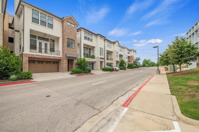view of road featuring street lighting, a residential view, sidewalks, and curbs