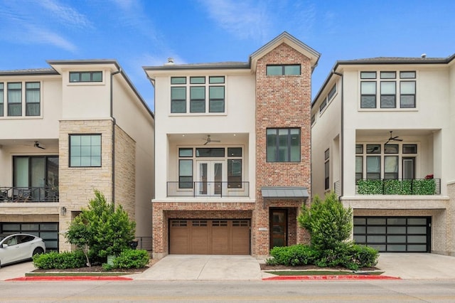 townhome / multi-family property featuring stucco siding, brick siding, driveway, and a garage