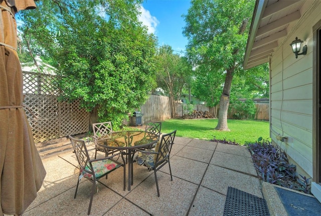 view of patio with a fenced backyard and outdoor dining area