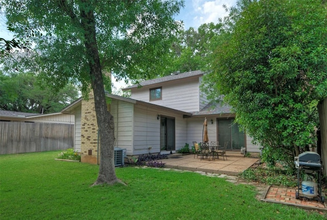rear view of property with a patio area, fence, and a yard
