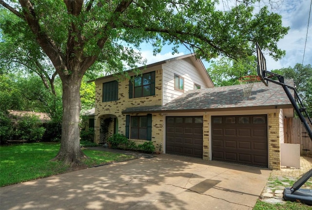 traditional home with an attached garage, concrete driveway, a front yard, and brick siding