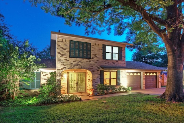 3003 Mohawk Rd, Austin, TX 78757 - view of front facade featuring brick siding, an attached garage, a front yard, french doors, and driveway