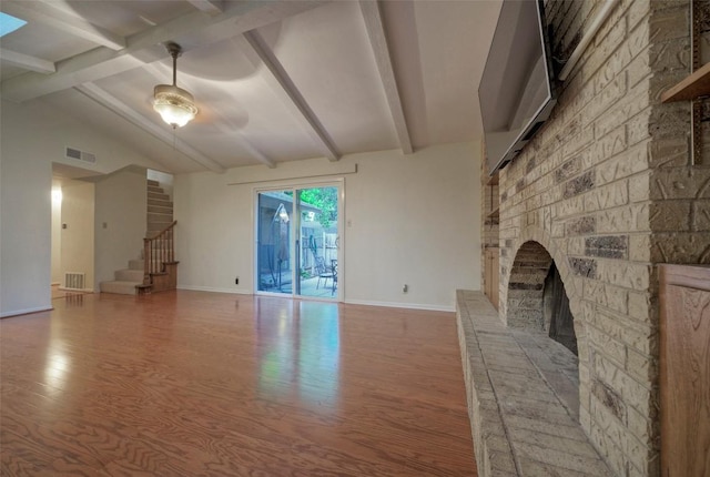 3003 Mohawk Rd, Austin, TX 78757 - unfurnished living room with wood finished floors, baseboards, stairway, and a fireplace