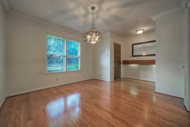 unfurnished dining area with baseboards, wood finished floors, and a notable chandelier