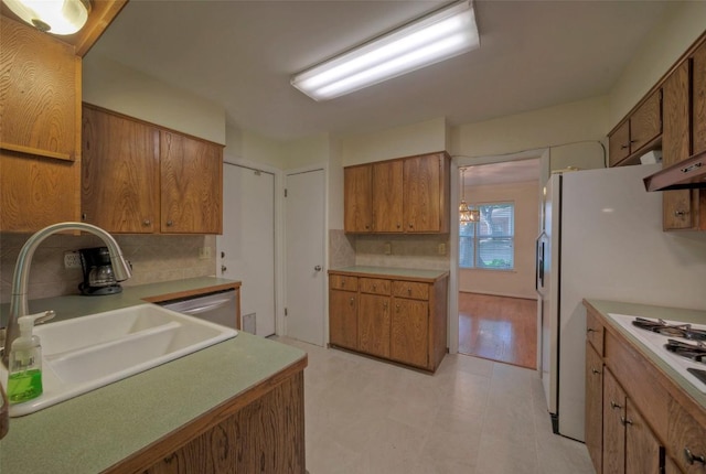 kitchen featuring a sink, backsplash, and brown cabinets