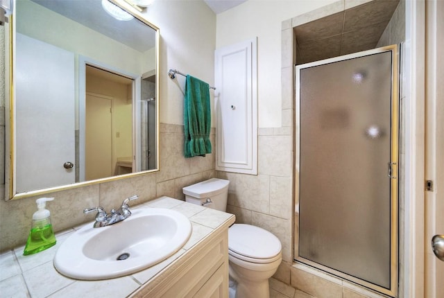 bathroom featuring vanity, tile walls, a stall shower, and toilet