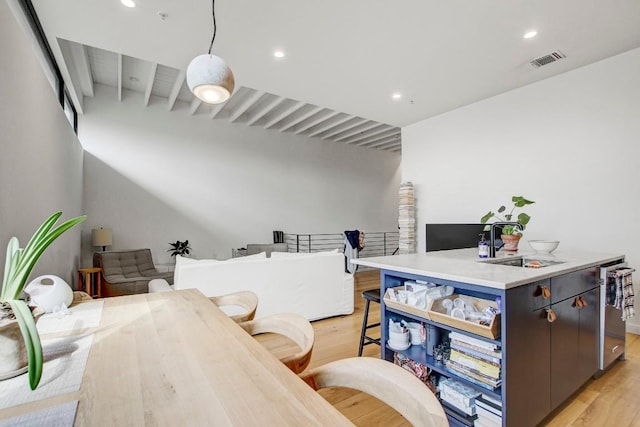 office area with visible vents, a sink, light wood finished floors, and recessed lighting