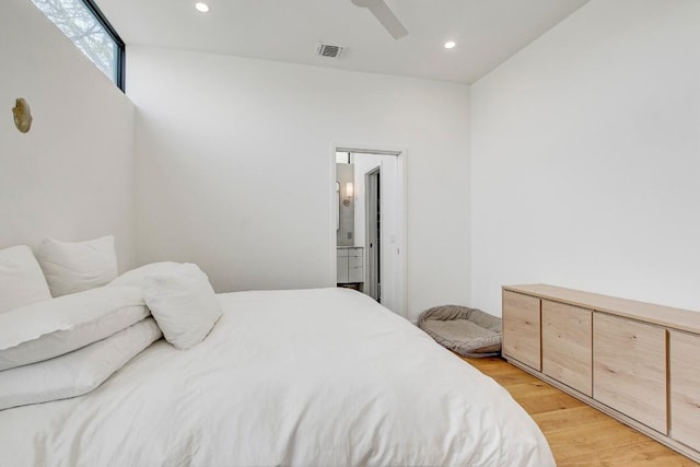 bedroom with ensuite bath, light wood-style floors, recessed lighting, a ceiling fan, and visible vents