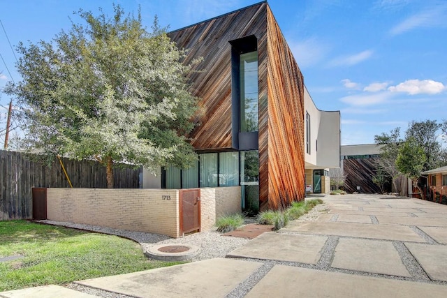 view of front of home featuring fence