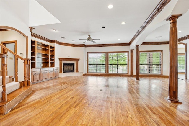 640 Woodlake Dr, Mcqueeney, TX 78123 - unfurnished living room with ceiling fan, decorative columns, ornamental molding, and light wood-style flooring