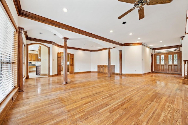 640 Woodlake Dr, Mcqueeney, TX 78123 - unfurnished living room with a ceiling fan, decorative columns, arched walkways, light wood-type flooring, and ornamental molding