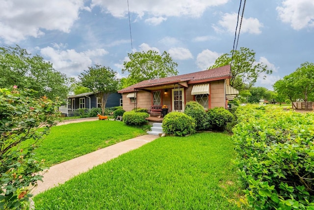 bungalow-style home with a front lawn