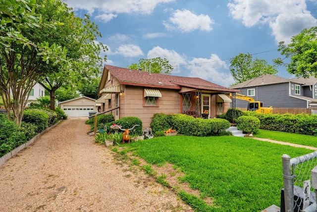 ranch-style house with a garage, fence, an outbuilding, and a front yard