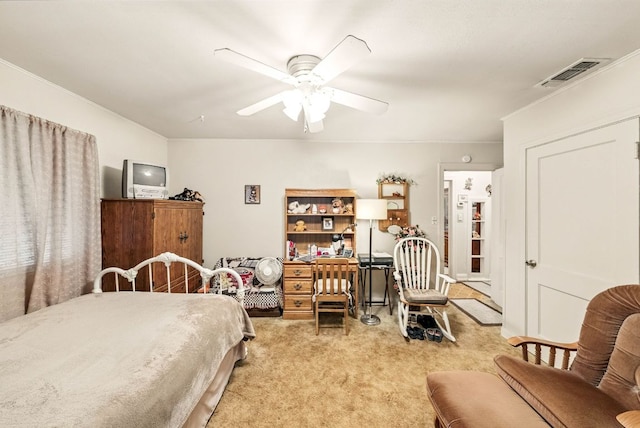 carpeted bedroom featuring crown molding, a ceiling fan, and visible vents