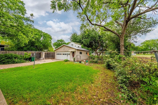 view of yard with fence and a garage