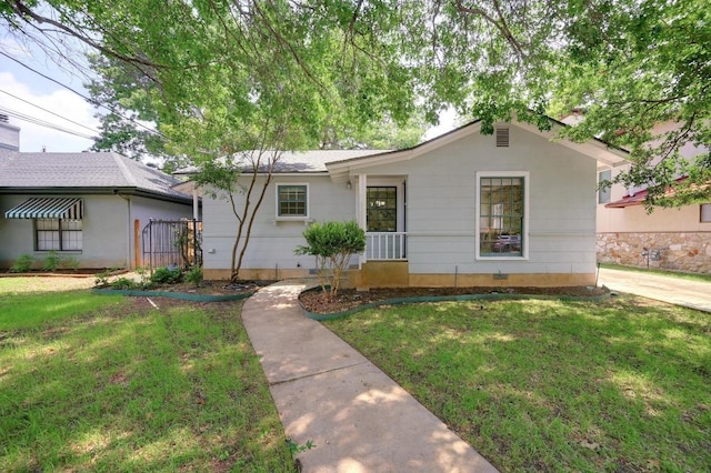ranch-style home featuring a front yard