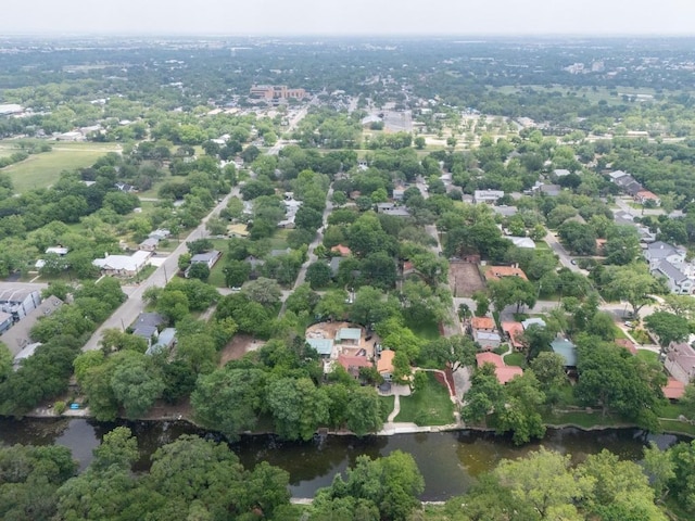 aerial perspective of suburban area with a nearby body of water