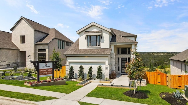 view of front of property with a gate, stucco siding, a front yard, and fence