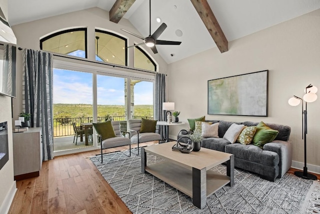 living area featuring wood-type flooring, baseboards, beam ceiling, and high vaulted ceiling