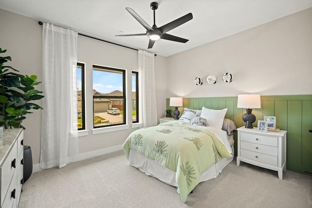 bedroom with a ceiling fan and light carpet