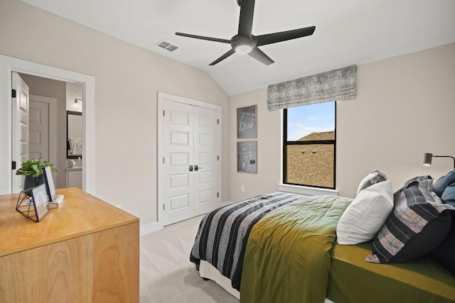 bedroom with ceiling fan, visible vents, light colored carpet, vaulted ceiling, and a closet