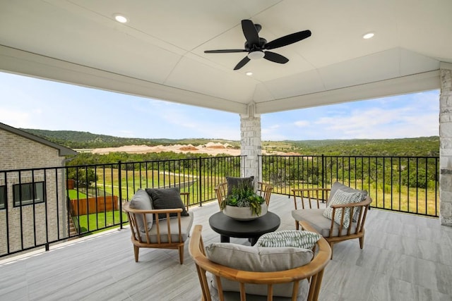 wooden deck featuring ceiling fan