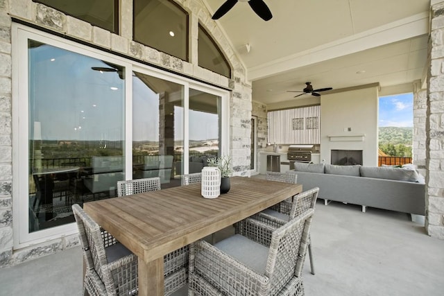 exterior space with a ceiling fan, an outdoor hangout area, and an outdoor kitchen