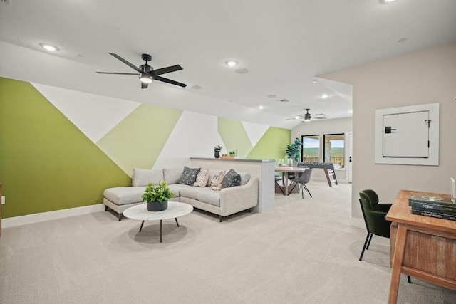 living area with baseboards, a ceiling fan, recessed lighting, and light colored carpet
