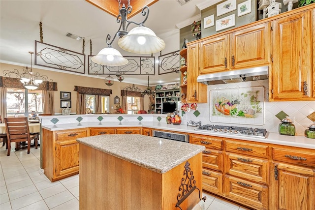 kitchen featuring a peninsula, stainless steel gas stovetop, light tile patterned floors, under cabinet range hood, and ornamental molding