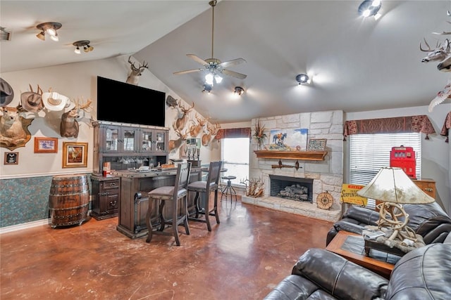 living room featuring concrete flooring, ceiling fan, lofted ceiling, and a fireplace