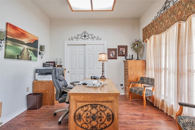 office space with baseboards and wood finished floors