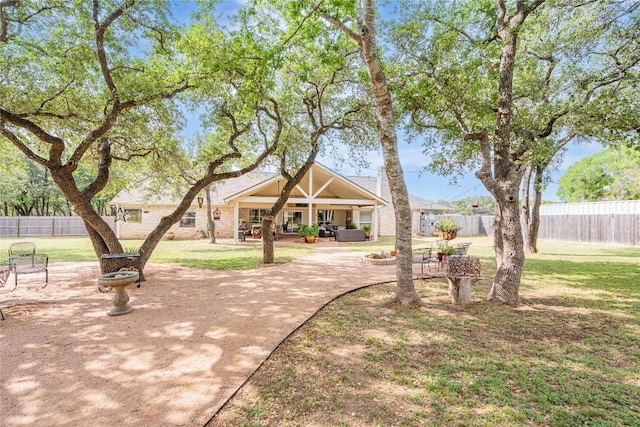 view of home's community featuring a yard, a patio, and fence
