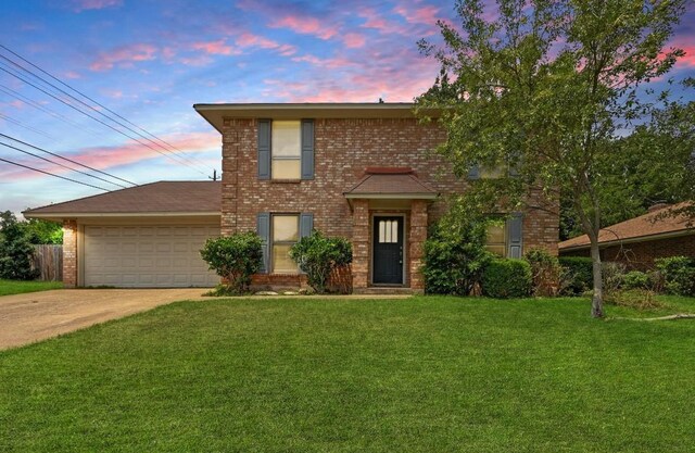 7304 Beckett Rd, Austin, TX 78749 - traditional home featuring a yard, a garage, driveway, and brick siding