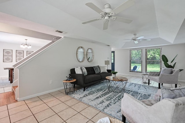 7304 Beckett Rd, Austin, TX 78749 - living room featuring a chandelier, ceiling fan, a tray ceiling, and light tile patterned floors