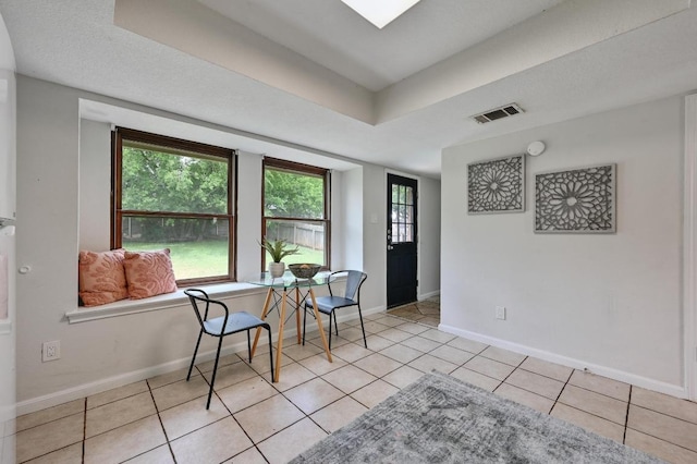 foyer with light tile patterned floors, baseboards, and visible vents