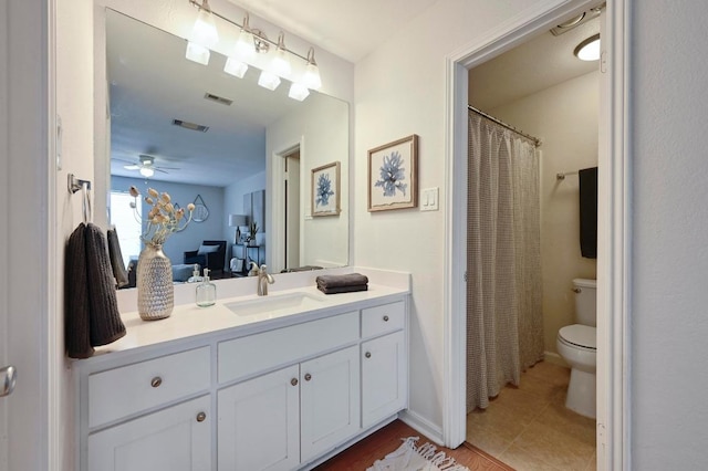 full bathroom featuring toilet, ceiling fan, visible vents, and vanity