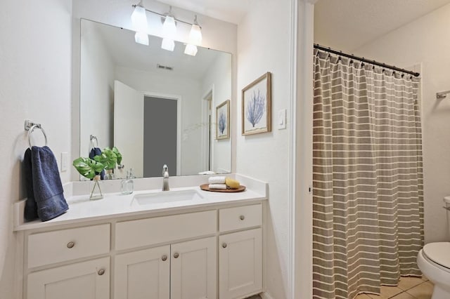 full bath with vanity, visible vents, toilet, tile patterned floors, and a shower with curtain