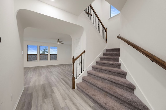 3944 Tufino Ln, Round Rock, TX 78665 - stairs with a ceiling fan, arched walkways, and wood finished floors