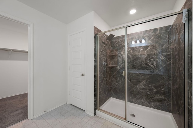 3944 Tufino Ln, Round Rock, TX 78665 - bathroom with a marble finish shower, recessed lighting, tile patterned flooring, a walk in closet, and baseboards