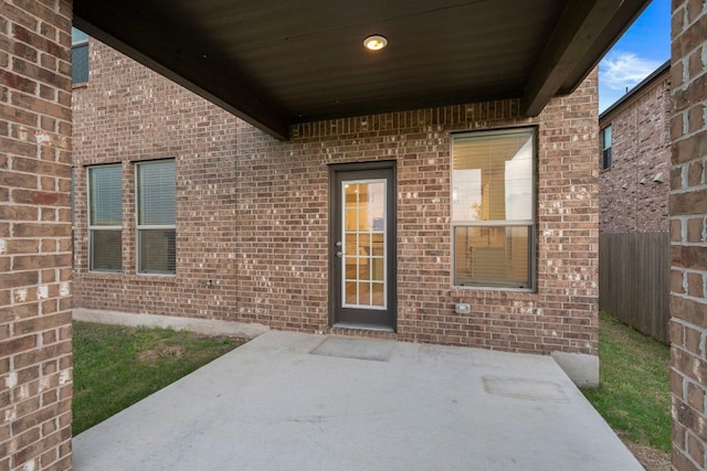3944 Tufino Ln, Round Rock, TX 78665 - doorway to property with a patio, brick siding, and fence