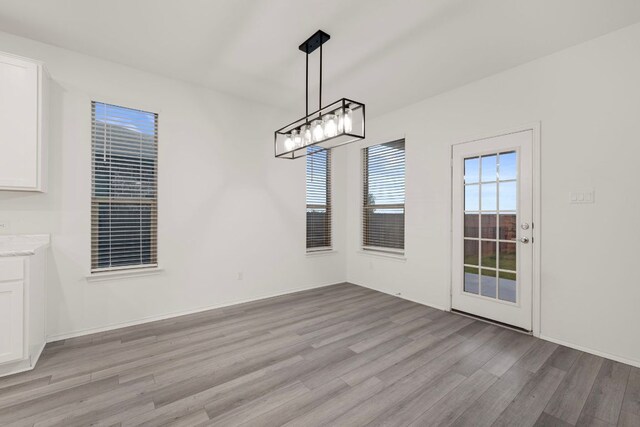 3944 Tufino Ln, Round Rock, TX 78665 - unfurnished dining area with light wood-style flooring and baseboards