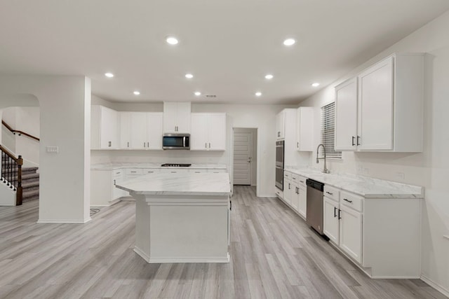 3944 Tufino Ln, Round Rock, TX 78665 - kitchen featuring light wood-type flooring, stainless steel appliances, baseboards, and a sink