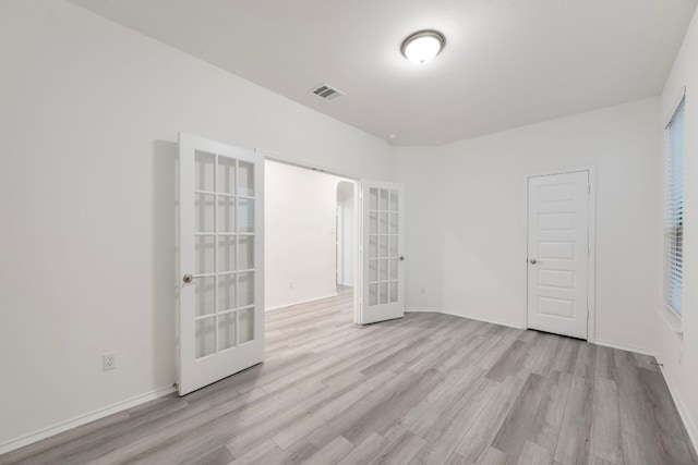 3944 Tufino Ln, Round Rock, TX 78665 - unfurnished bedroom featuring light wood-style flooring, baseboards, french doors, and visible vents