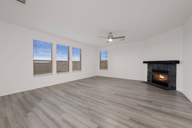 3944 Tufino Ln, Round Rock, TX 78665 - unfurnished living room featuring visible vents, a fireplace, ceiling fan, and wood finished floors