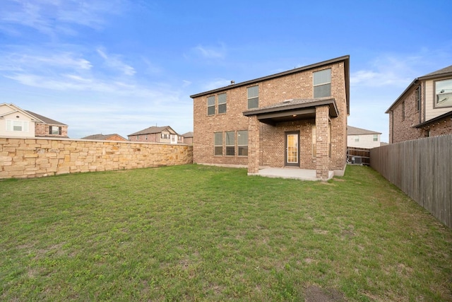 3944 Tufino Ln, Round Rock, TX 78665 - back of property with a yard, brick siding, a patio area, and a fenced backyard