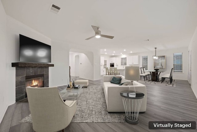 3944 Tufino Ln, Round Rock, TX 78665 - living area with ceiling fan, a fireplace, visible vents, and wood finished floors
