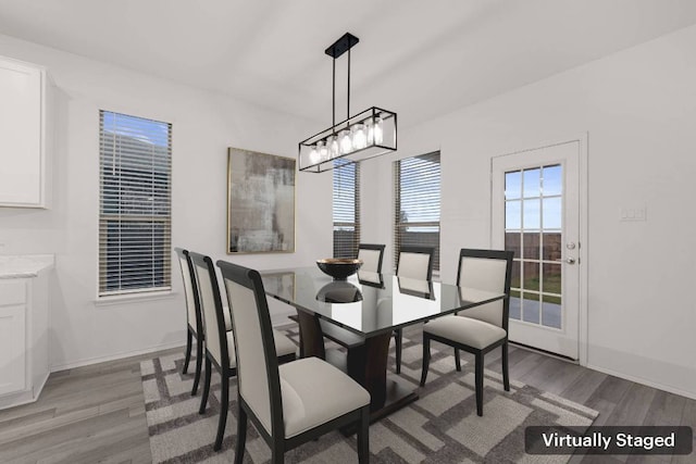 3944 Tufino Ln, Round Rock, TX 78665 - dining room featuring an inviting chandelier, light wood-type flooring, and baseboards