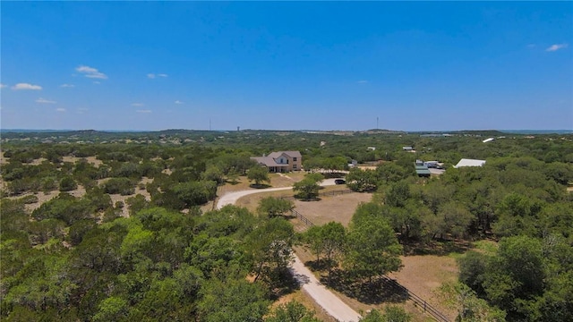 birds eye view of property featuring a forest view